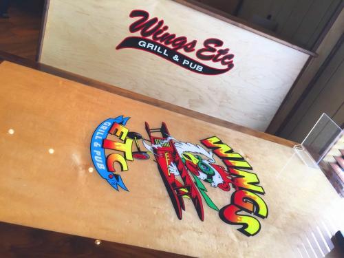 Wings Etc. Logo on Table